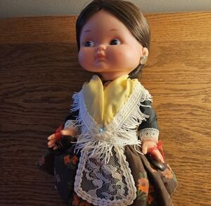 Vintage Doll with Floral Dress and Yellow Accents